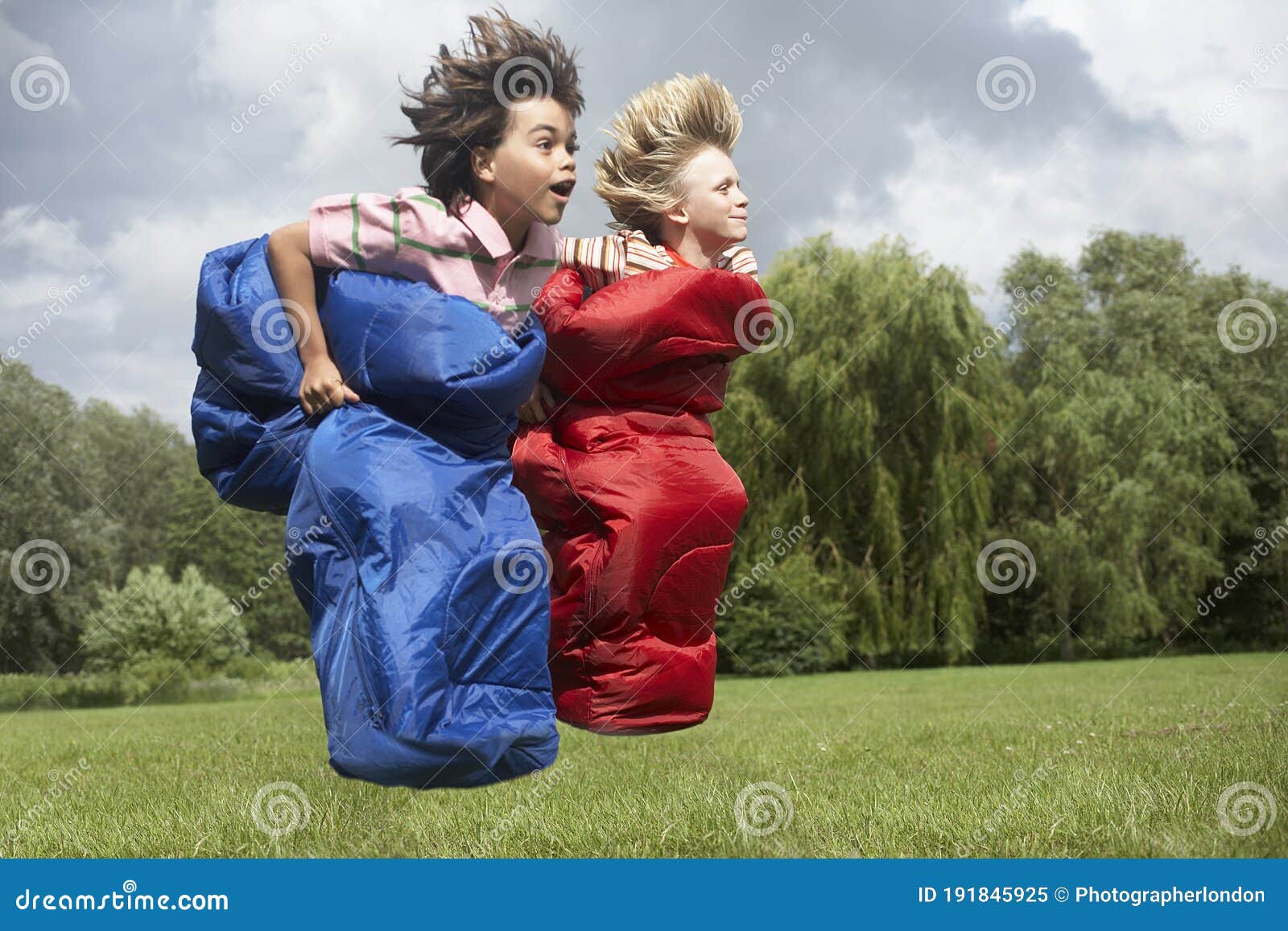 Two Boys Sack Racing in Sleeping Bags Stock Image Image of outdoor, skill 191845925