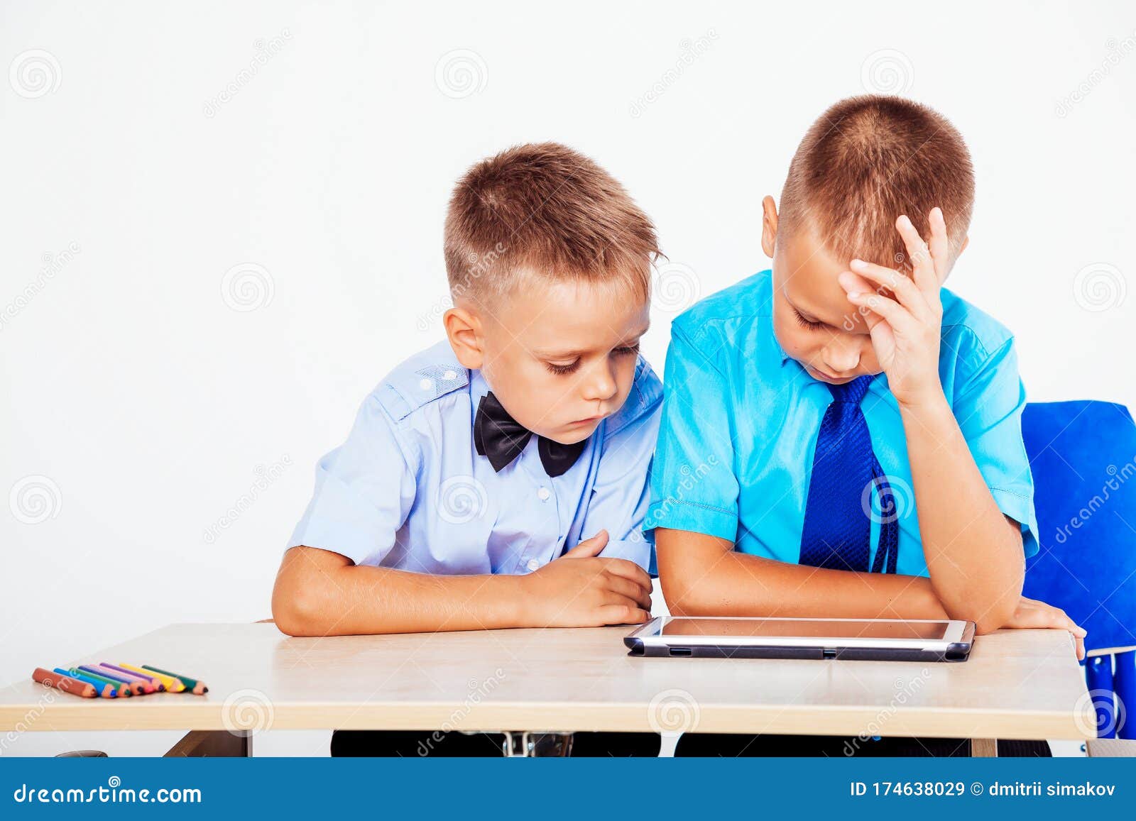 Two Boys Sit at a Desk and Looking Tablet Stock Image Image of