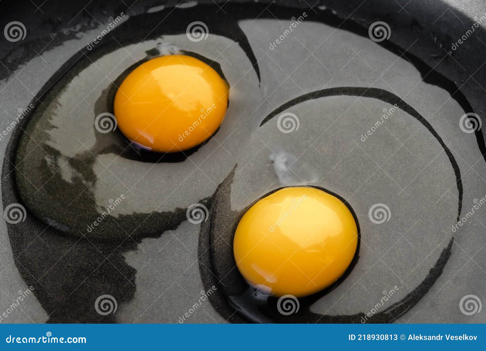 Two Bright Round Yolks in Raw Whites, Uncooked Small Fried Eggs is a