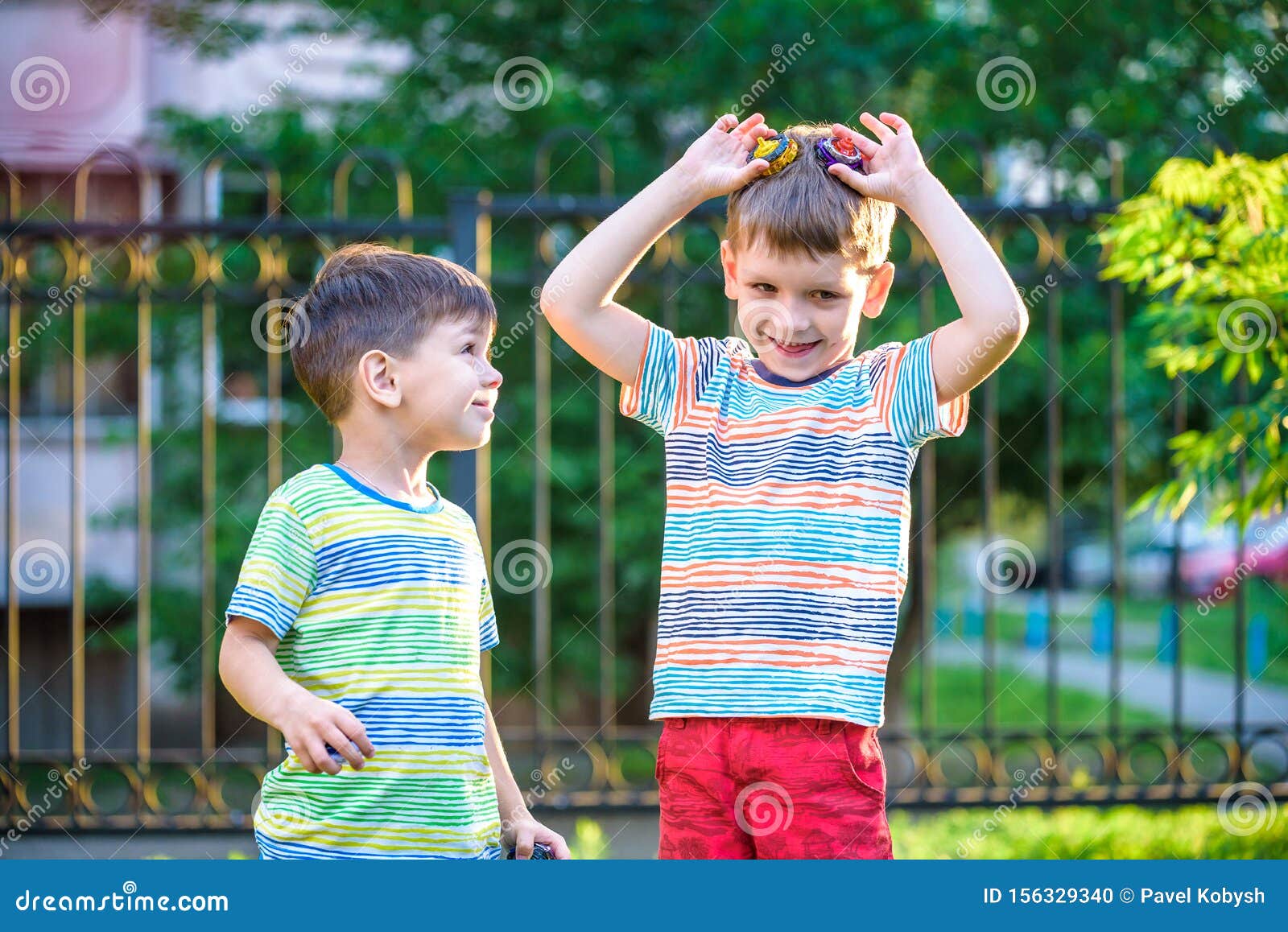 Play span. Two boys playing. Playing with a Spinner for children. Kids playing Spinner.