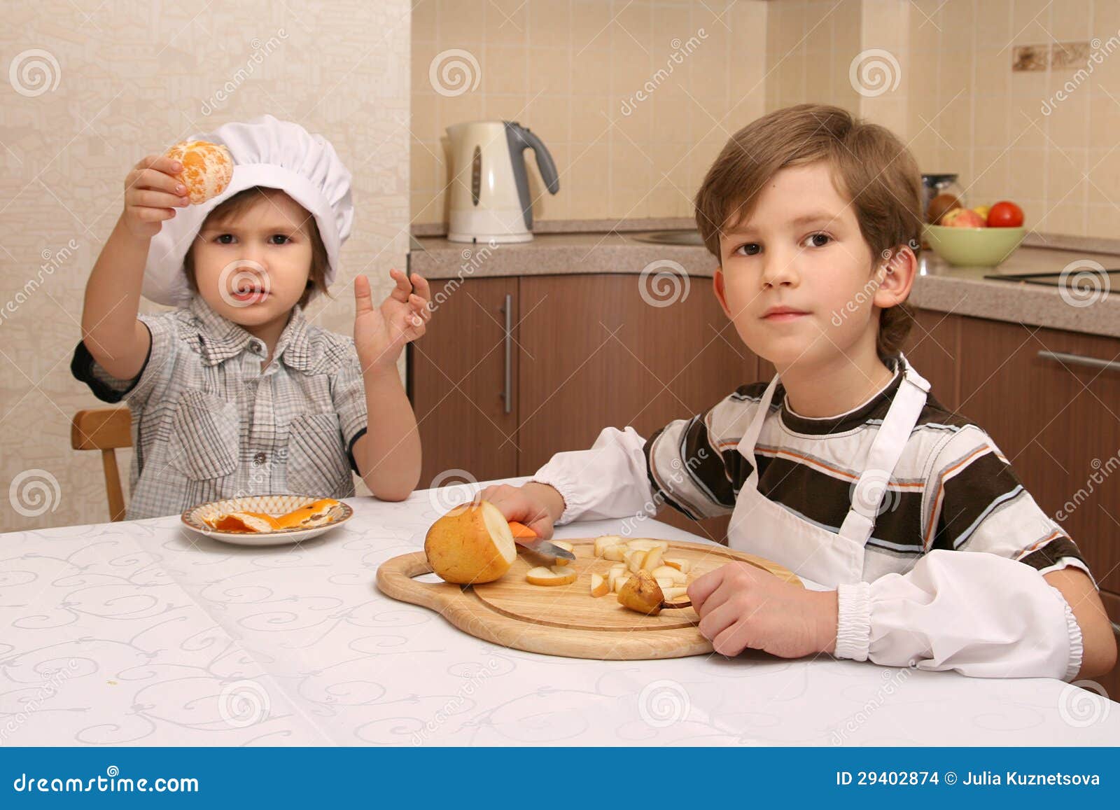 Two brothers in kitchen stock photo. Image of knife, table 29402874