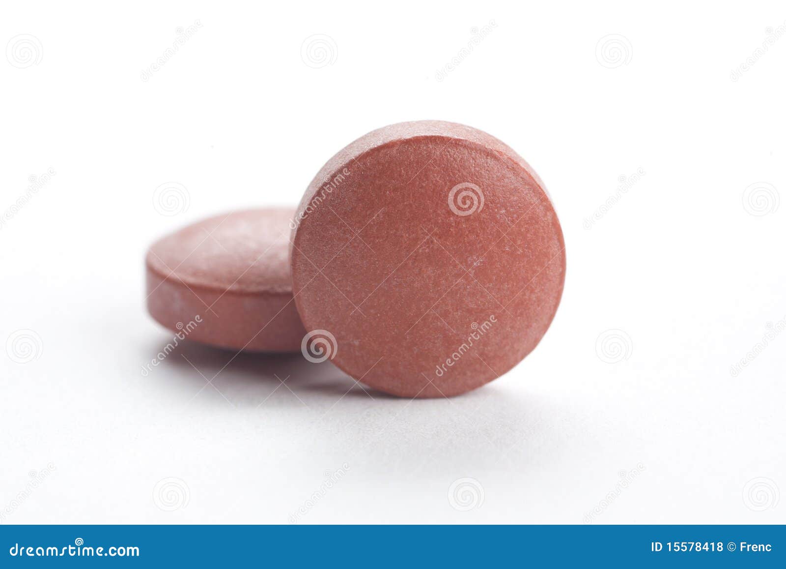 Two brown pills, isolated stock photo. Image of pain 15578418
