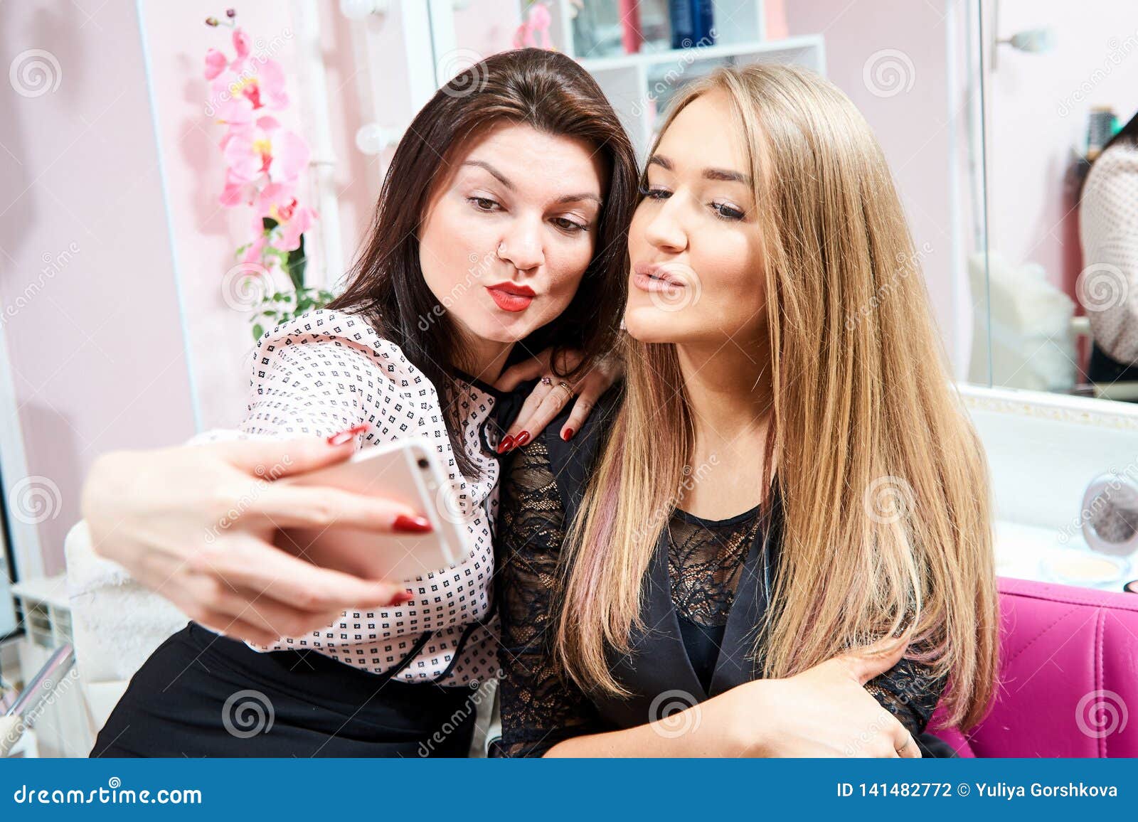 Two Brunette Girls and a Blonde Make a Selfie in a Beauty Salon Stock ...