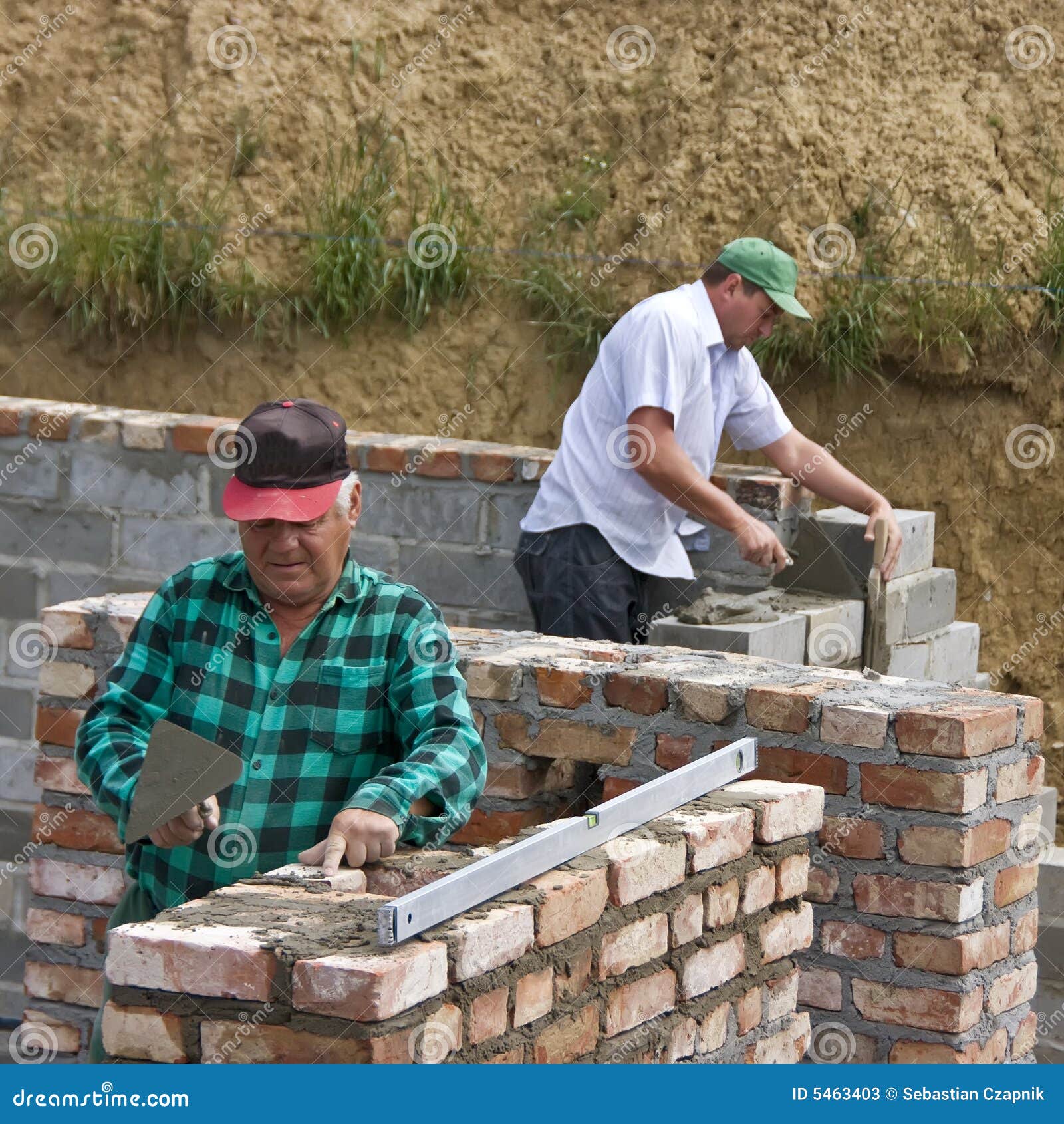 two builders making walls