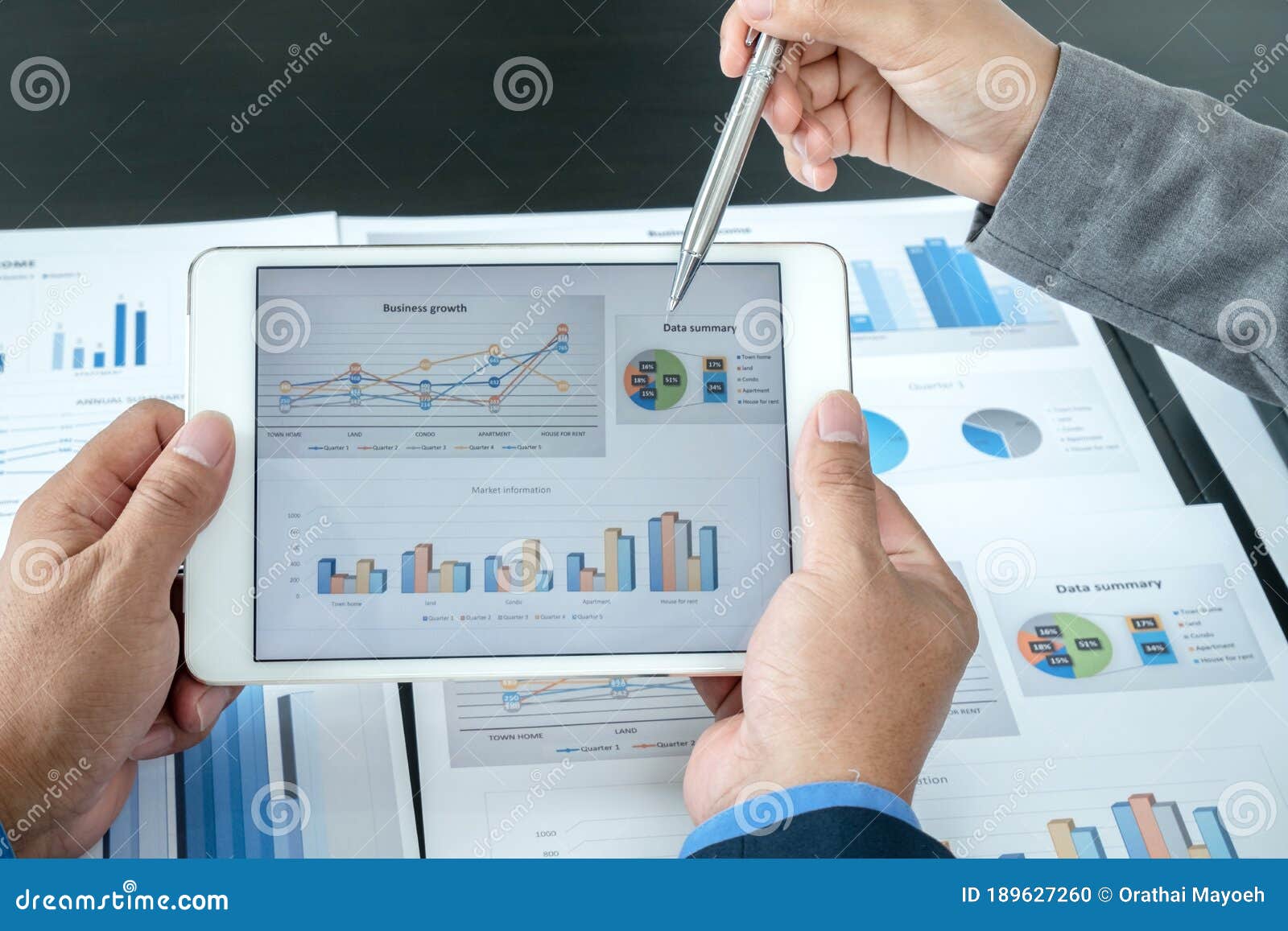 two business leaders talk about charts, financial graphs showing results are analyzing and calculating planning strategies,