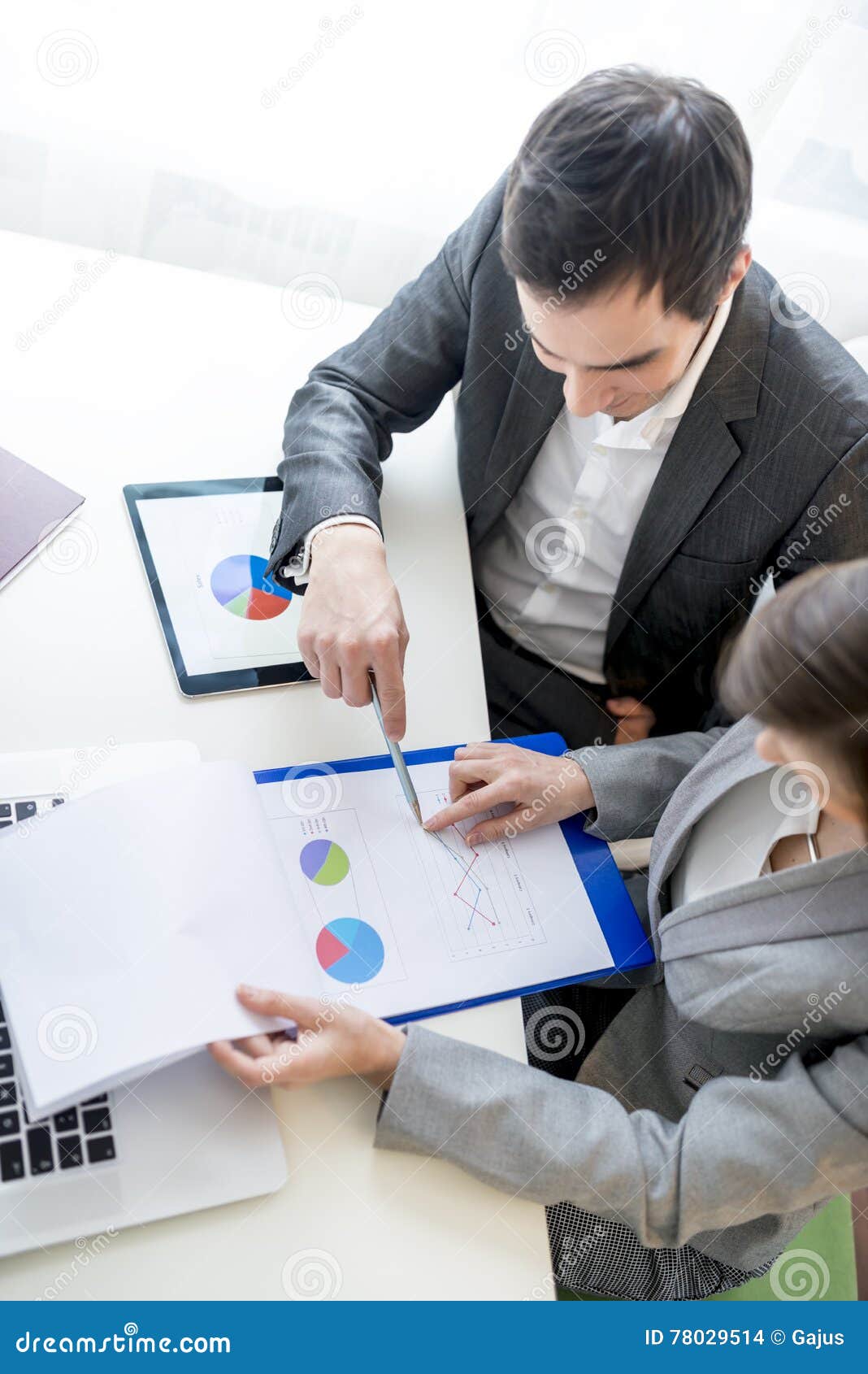 two business partners analysing a report