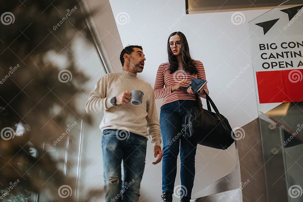 Casual Business Colleagues with Coffee Walking Down Office Stairs ...