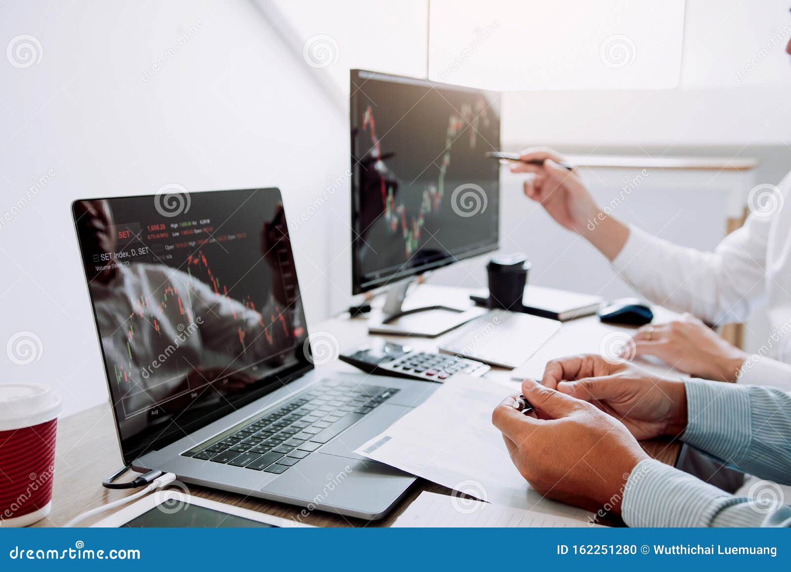 two business stock brokers stress and looking at monitors displaying financial stock graph report information