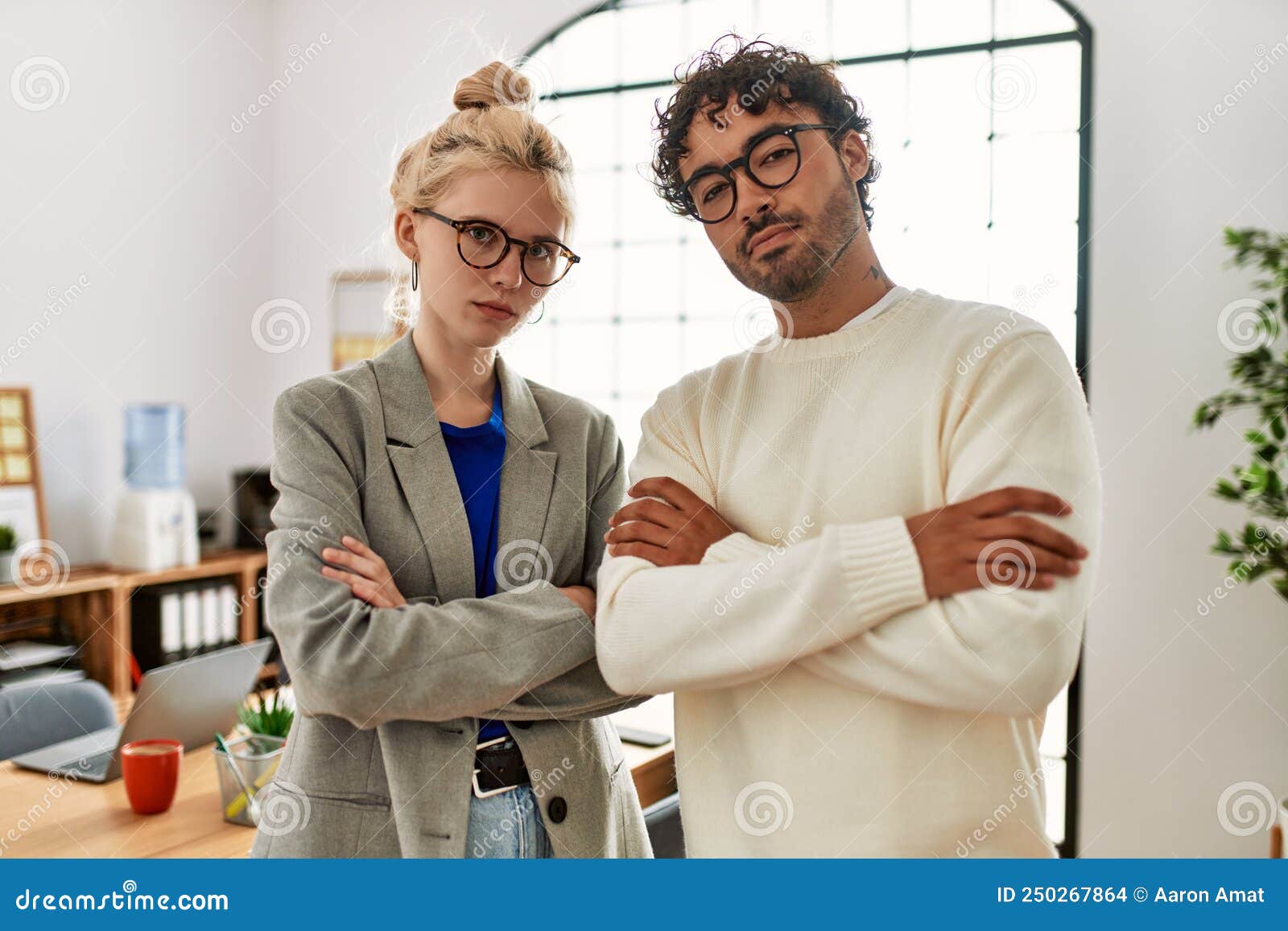 Two Business Workers Standing with Arms Crossed Gesture at the Office