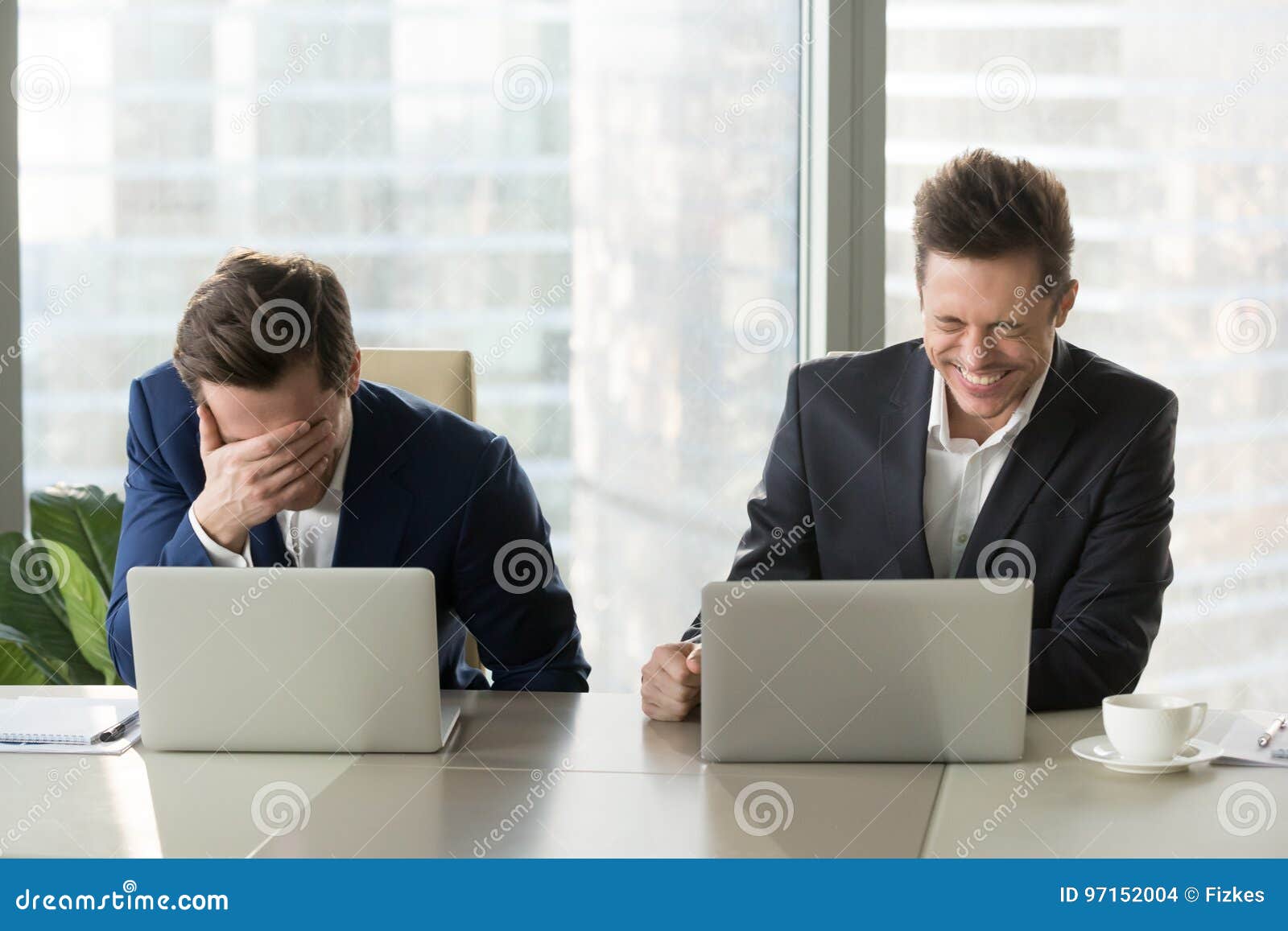 two businessmen laughing out loud, good positive emotions at wor