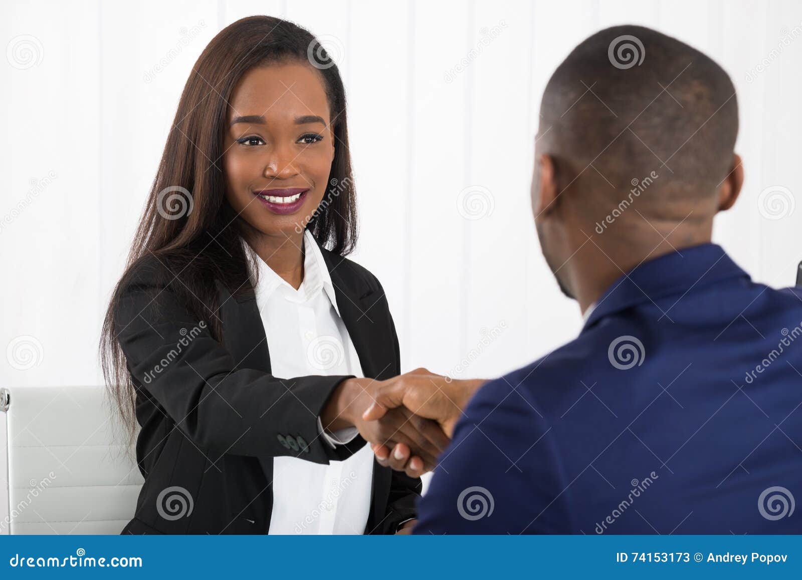 two businesspeople shaking hands at office