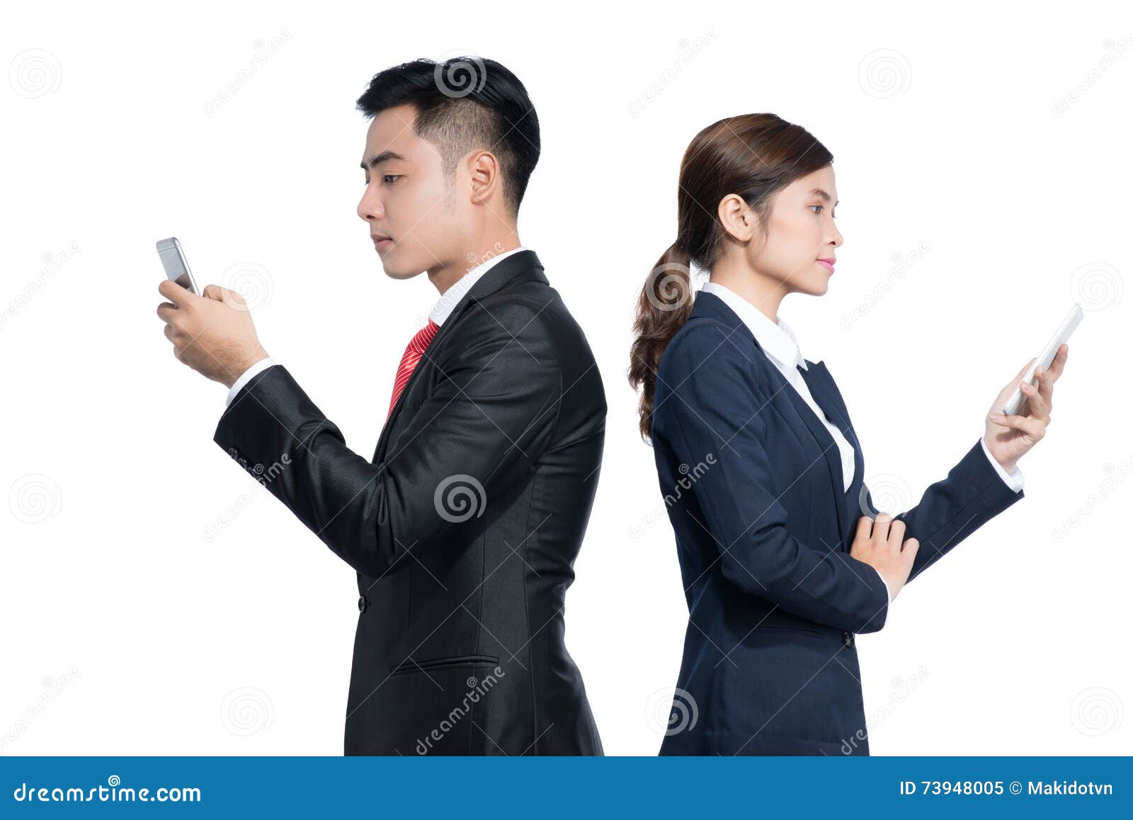 Two Businesspeople Standing Using Smart Mobile Phone Stock Image