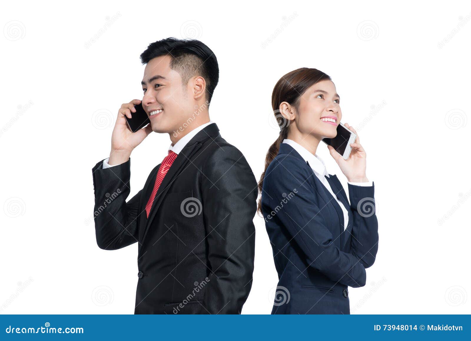 Two Businesspeople Standing Using Smart Mobile Phone Stock Photo