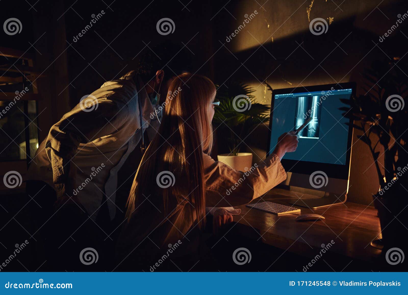 two docters are working in the dark office