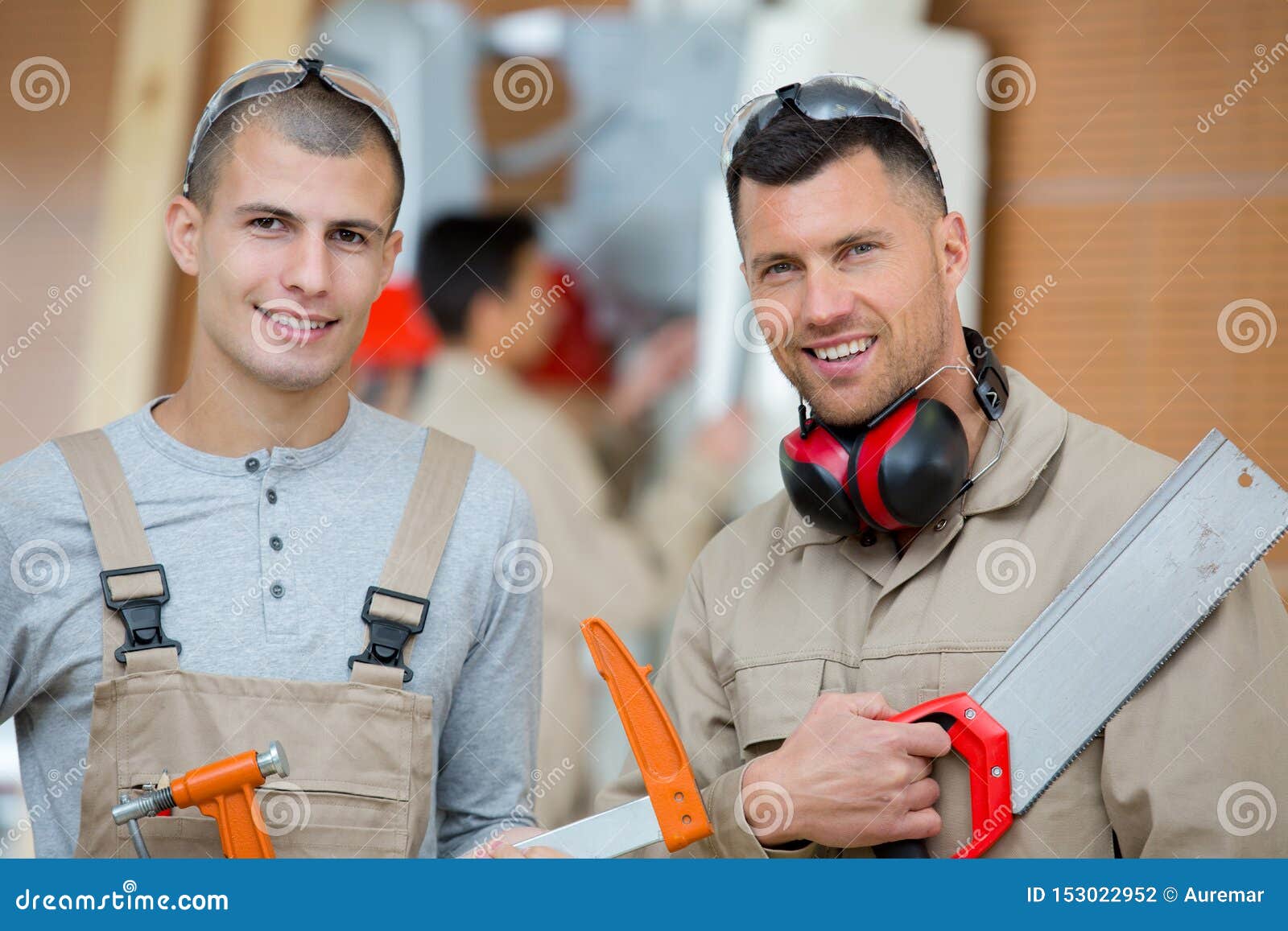two carpenters posing to camera