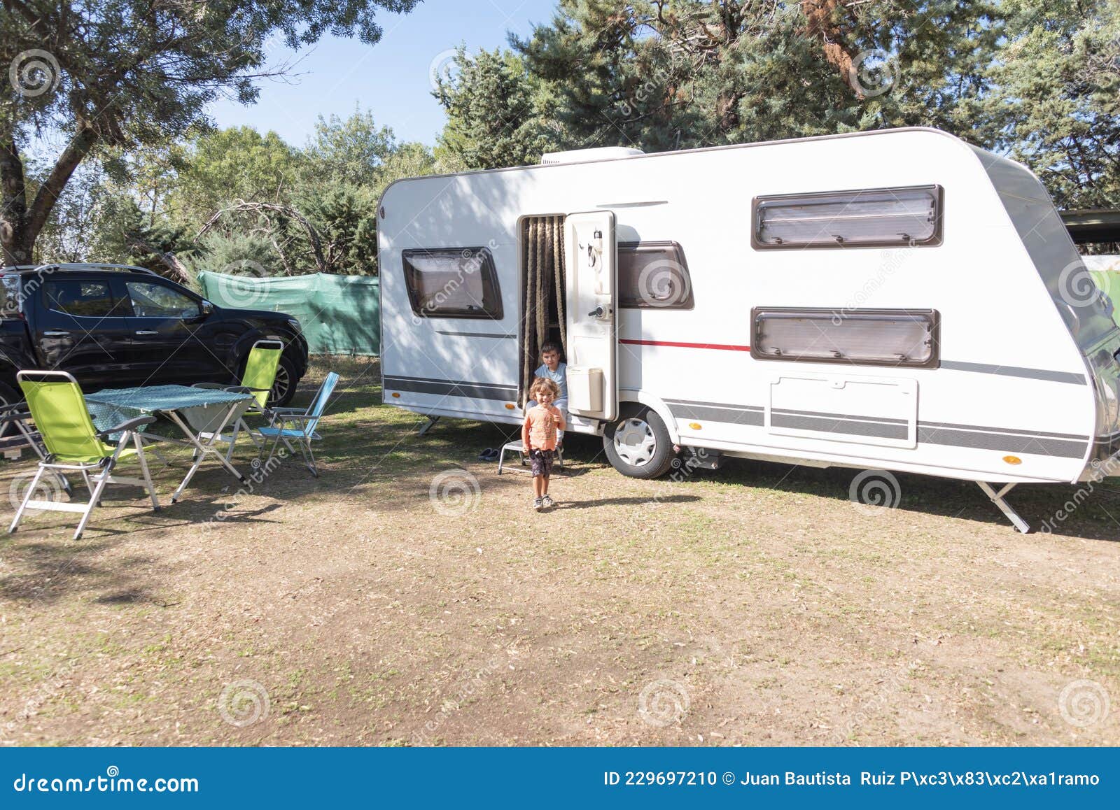 Two Caucasian Children Play and Spend Alternative Holidays in a Caravan