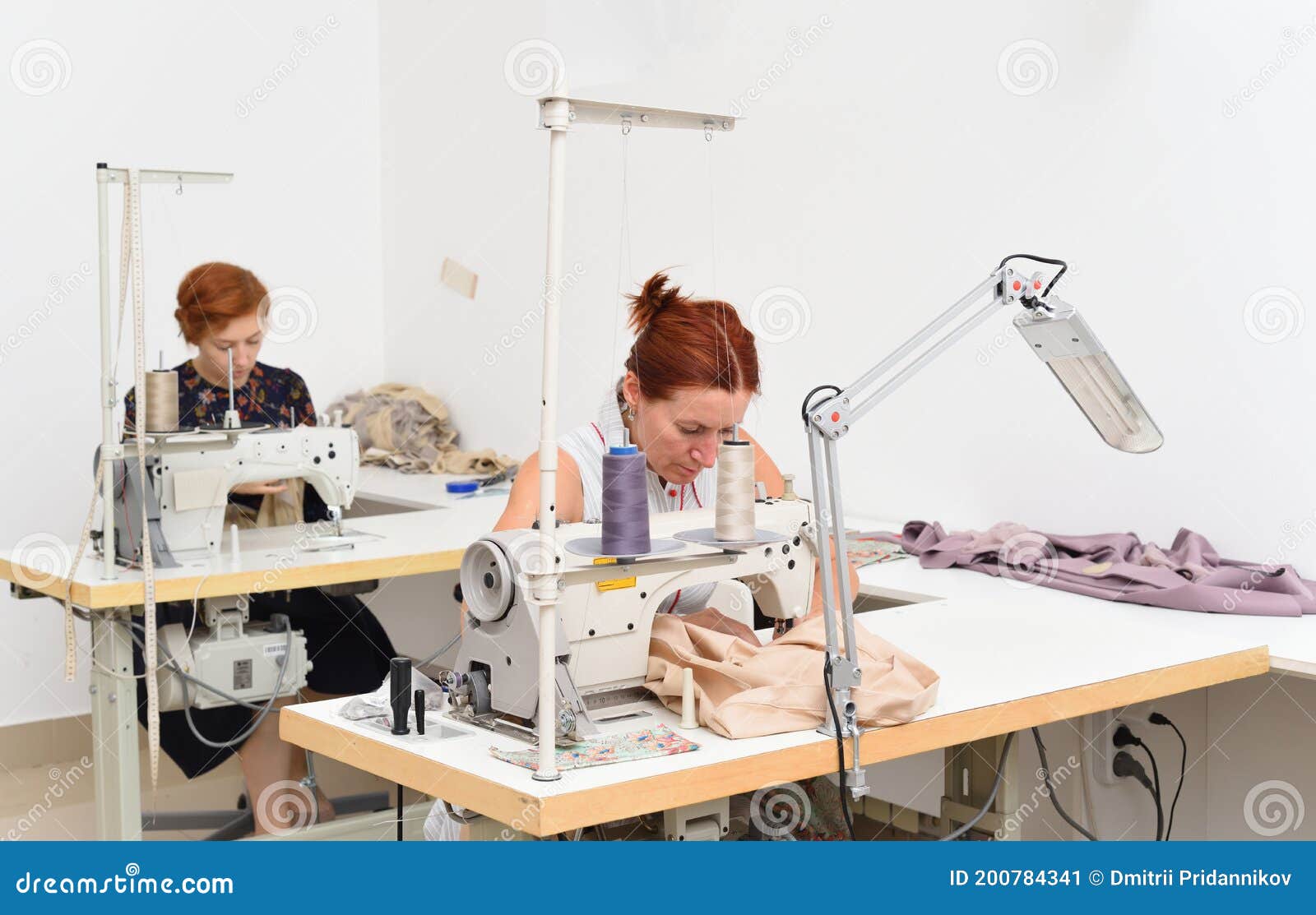 Two Caucasian Women Seamstress at Work on Sewing Machines in a Sewing