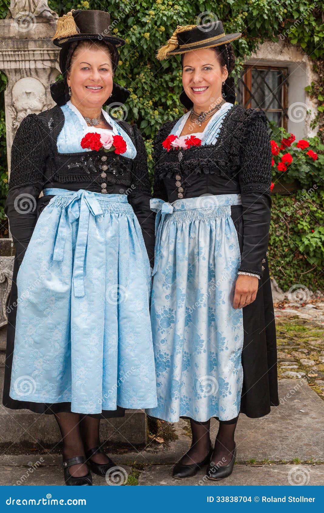 Two Charming Ladies In Traditional Dirndls Stock Photo 