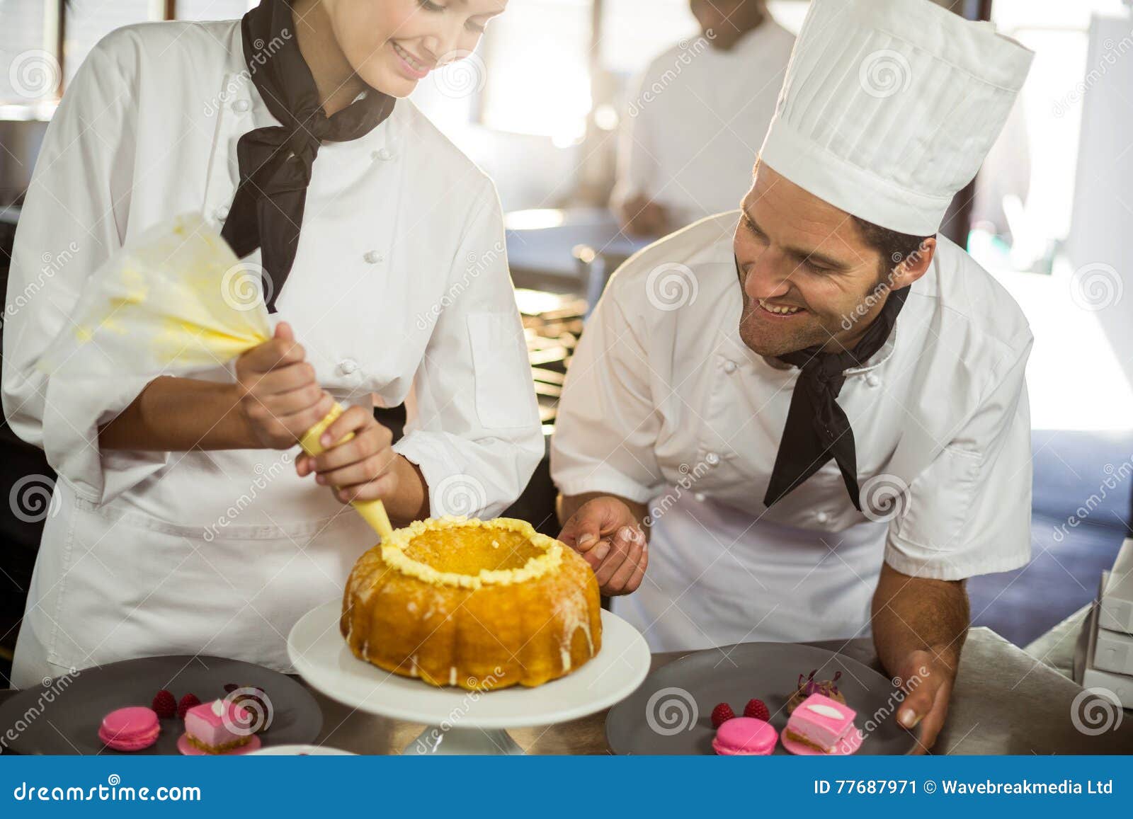 Two chefs preparing a cake stock image. Image of cake 77687971