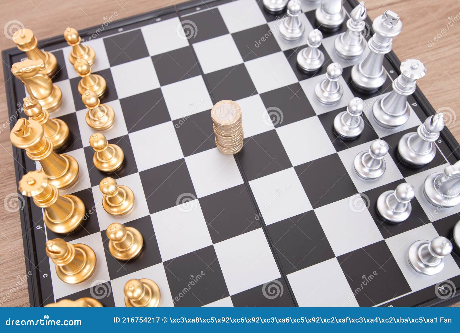 the two chess pieces placed on the chess board and the euro coin in the middle ready to be contested