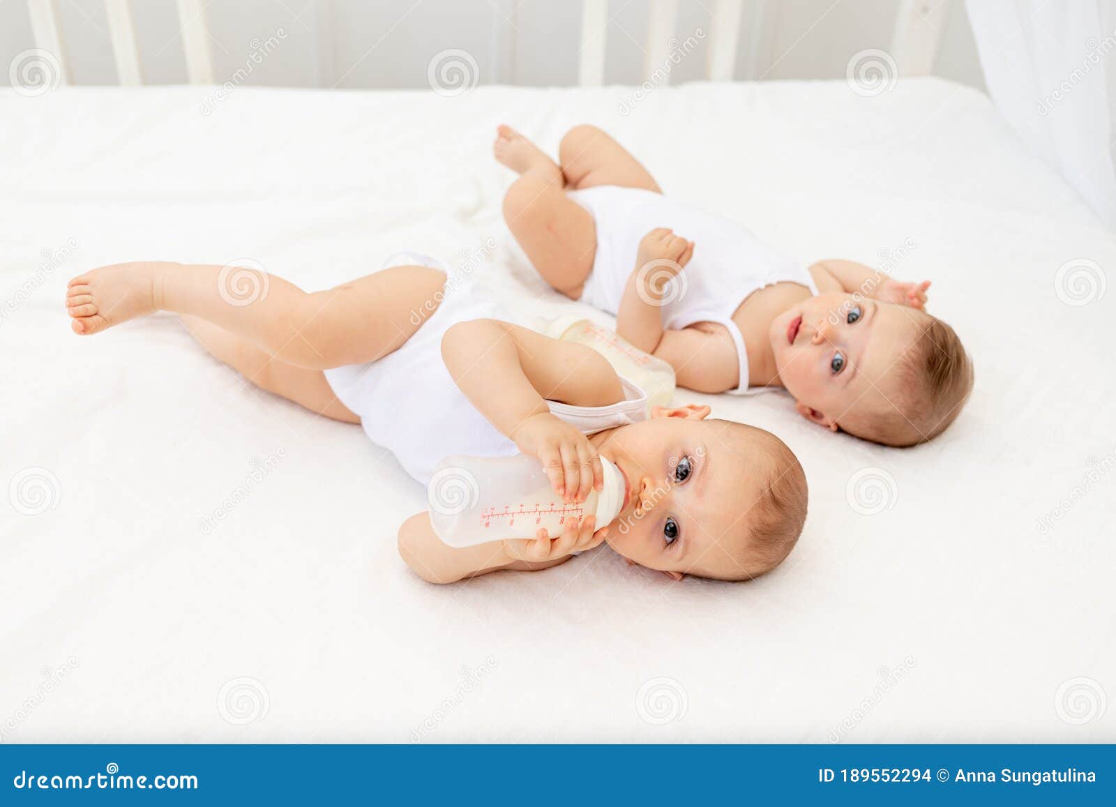 Two naked girls playing with one boy