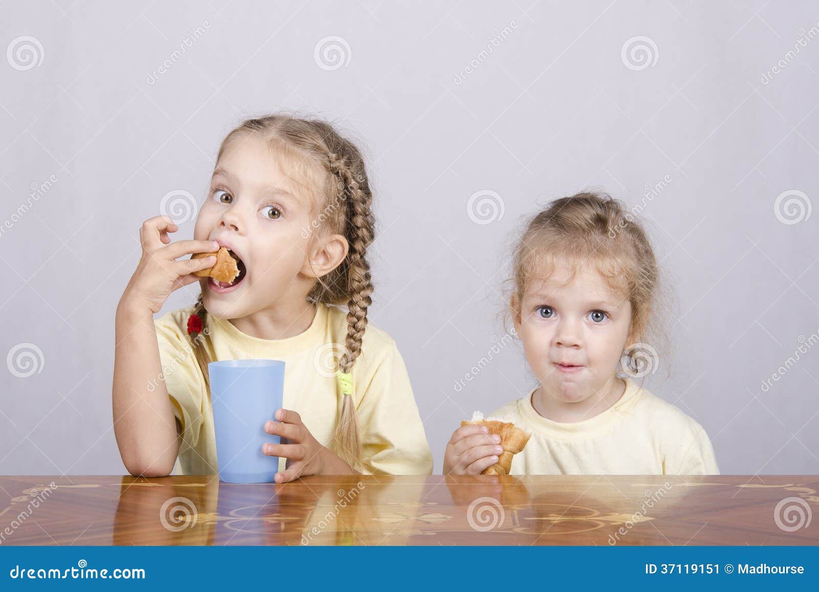 Two Children Eat a Muffin at the Table Stock Image Image of croissant