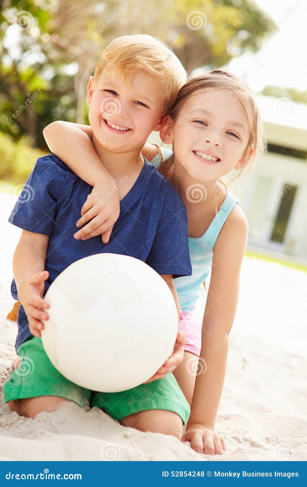 Two Children Playing Game of Volleyball in Garden Stock Photo Image
