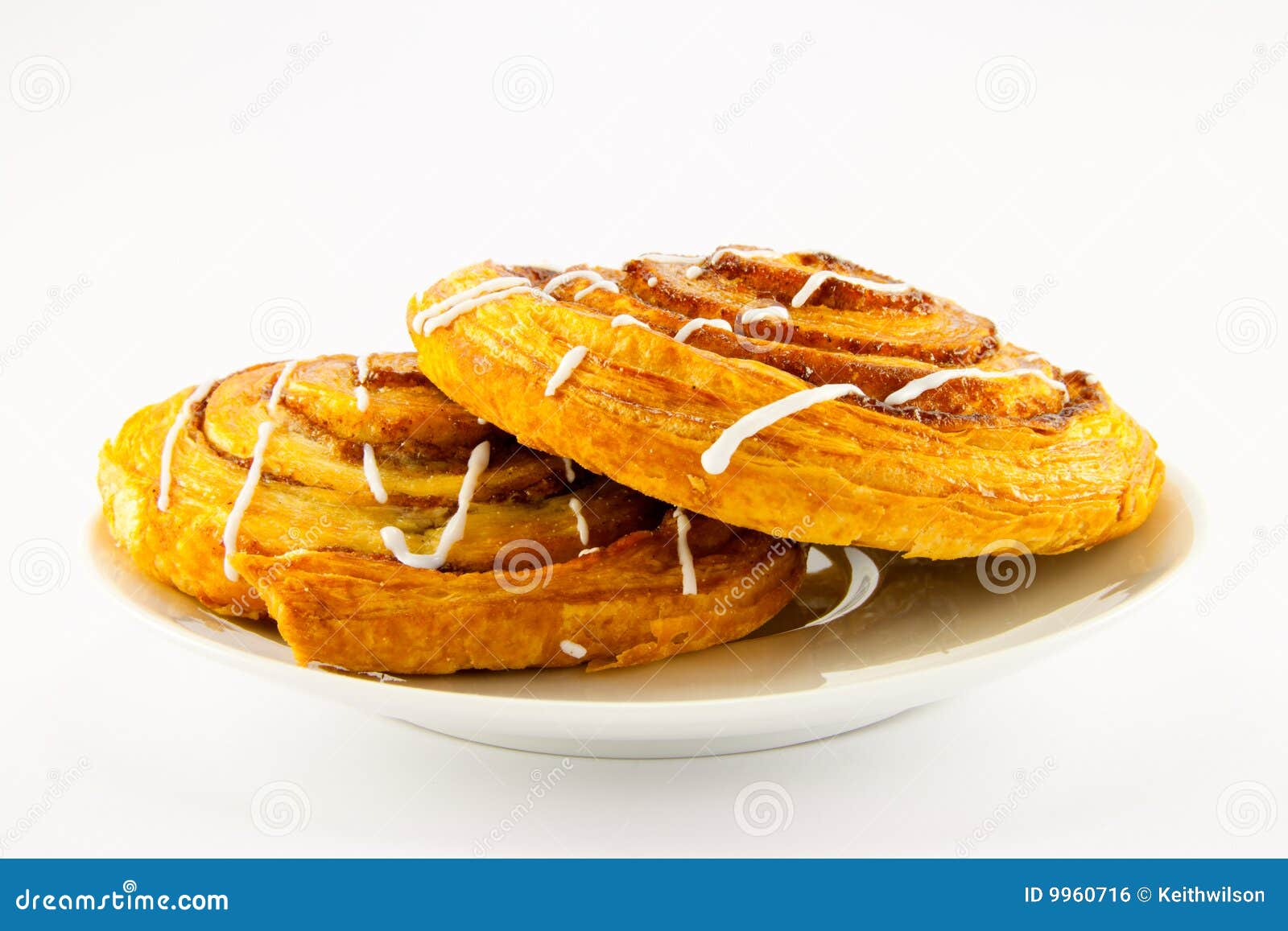 Two Cinnamon Buns On A White Plate Stock Photo Image of glaze, cake