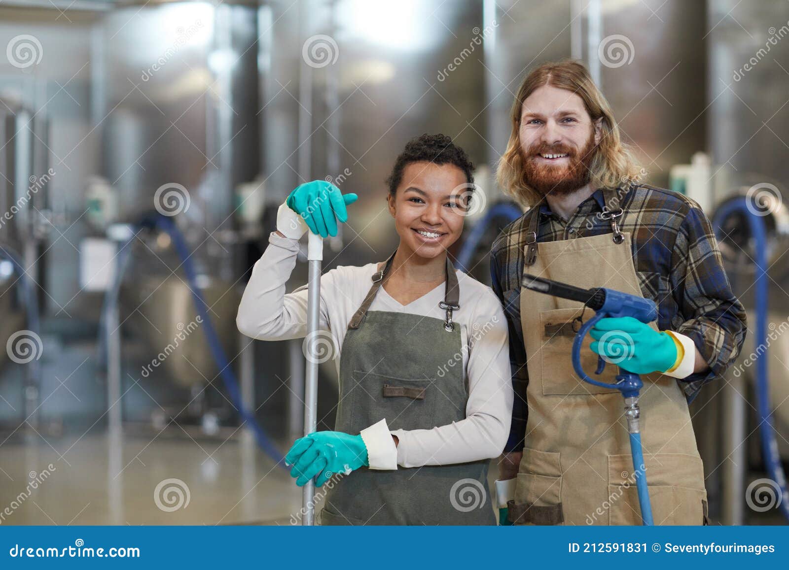 two cleaning workers smiling at camera