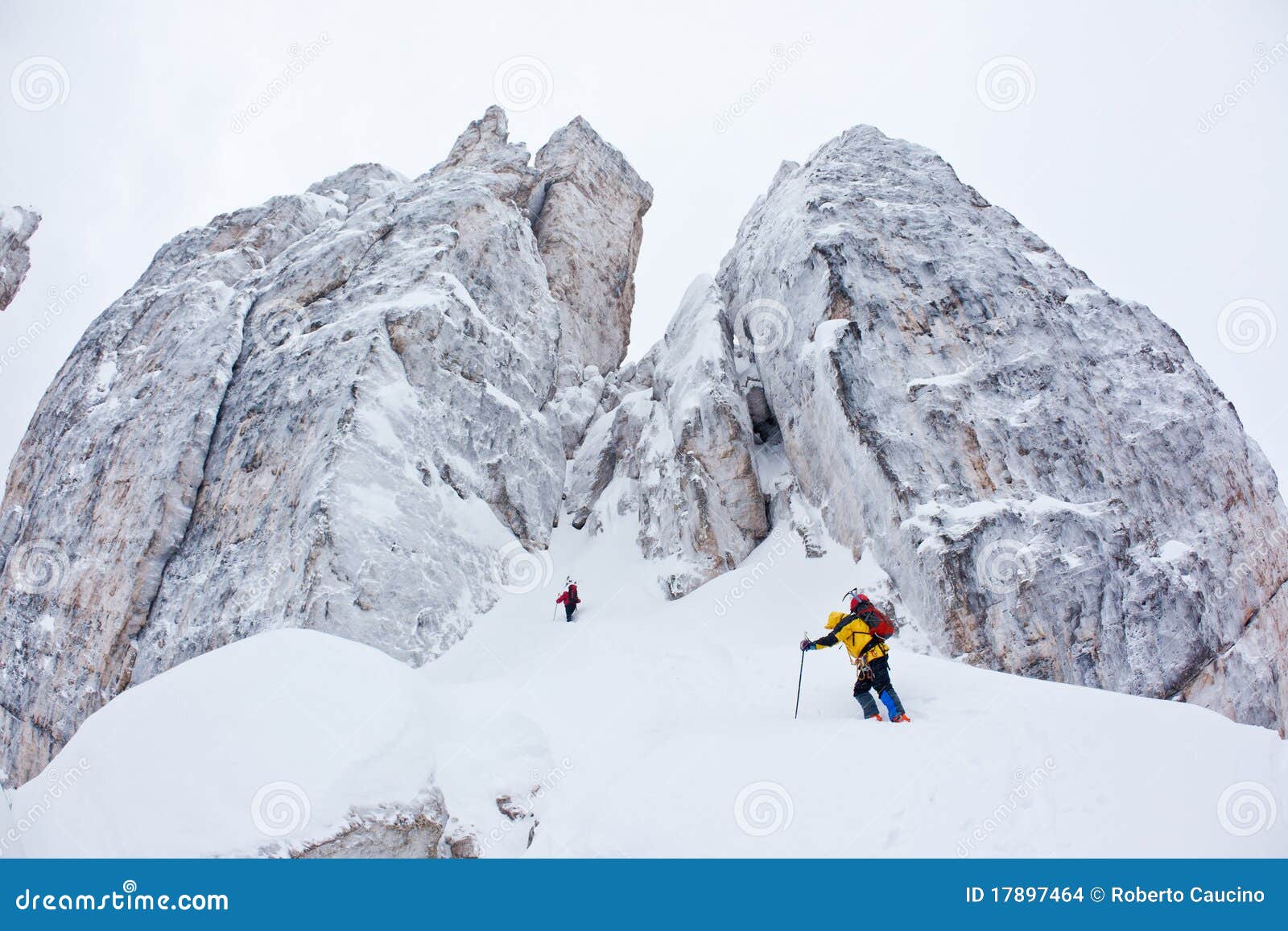two climbers approach to a winter steep face
