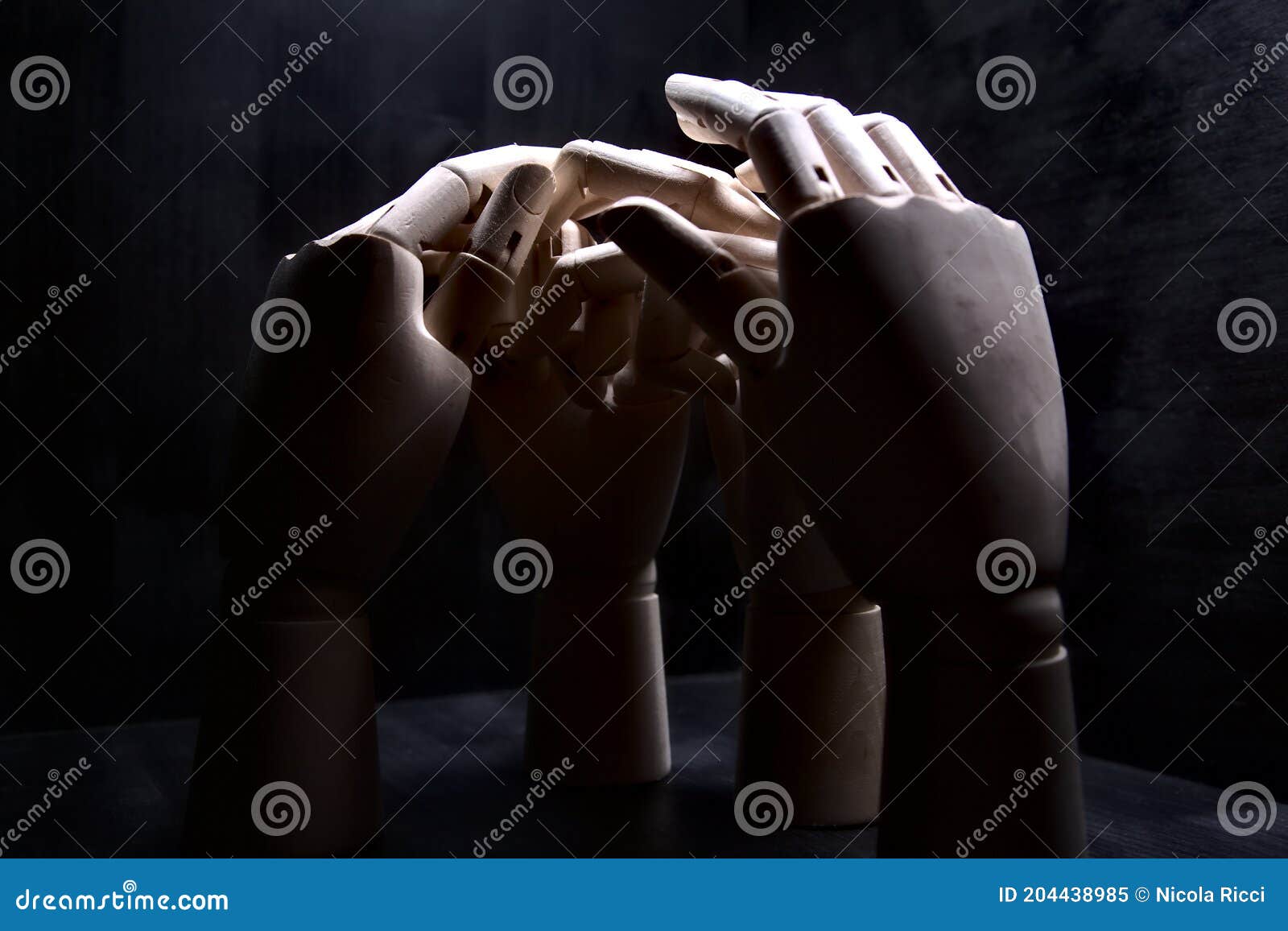 Two Closed Wooden Hands in a Shy Stance while Two Other Hands are ...