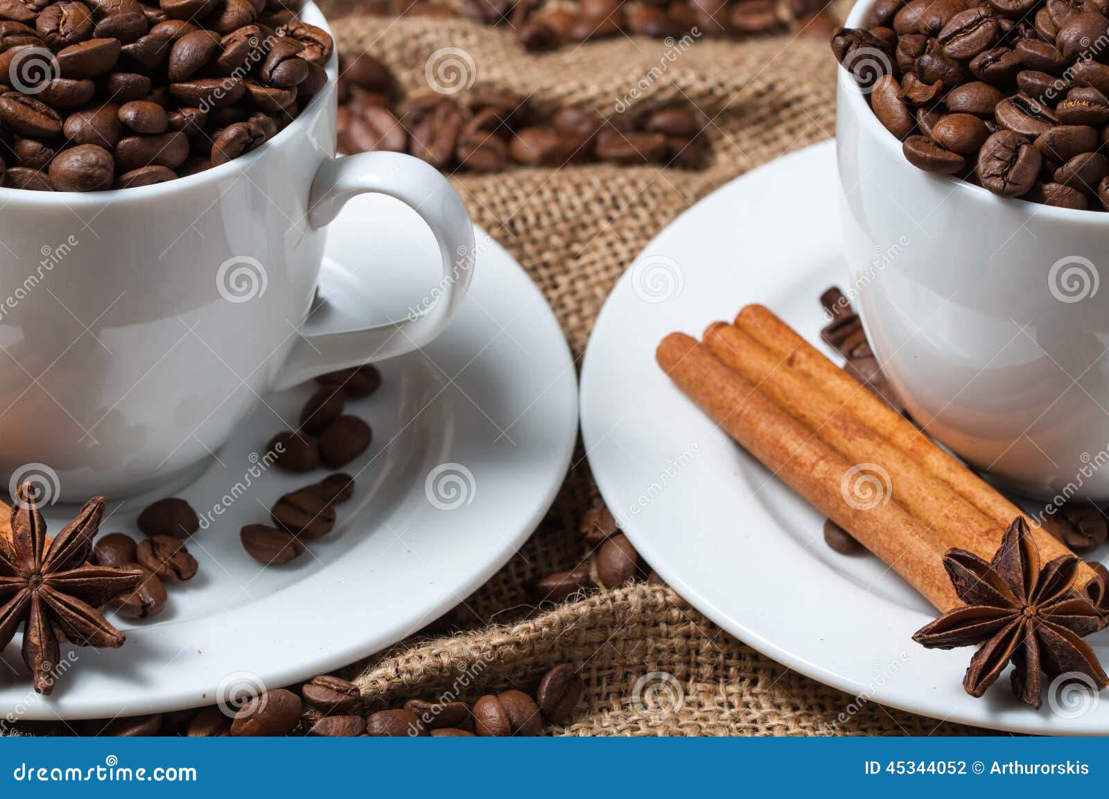 Two Coffee Cups with Coffee Beans, Aniseed and Cinnamon. Stock Photo