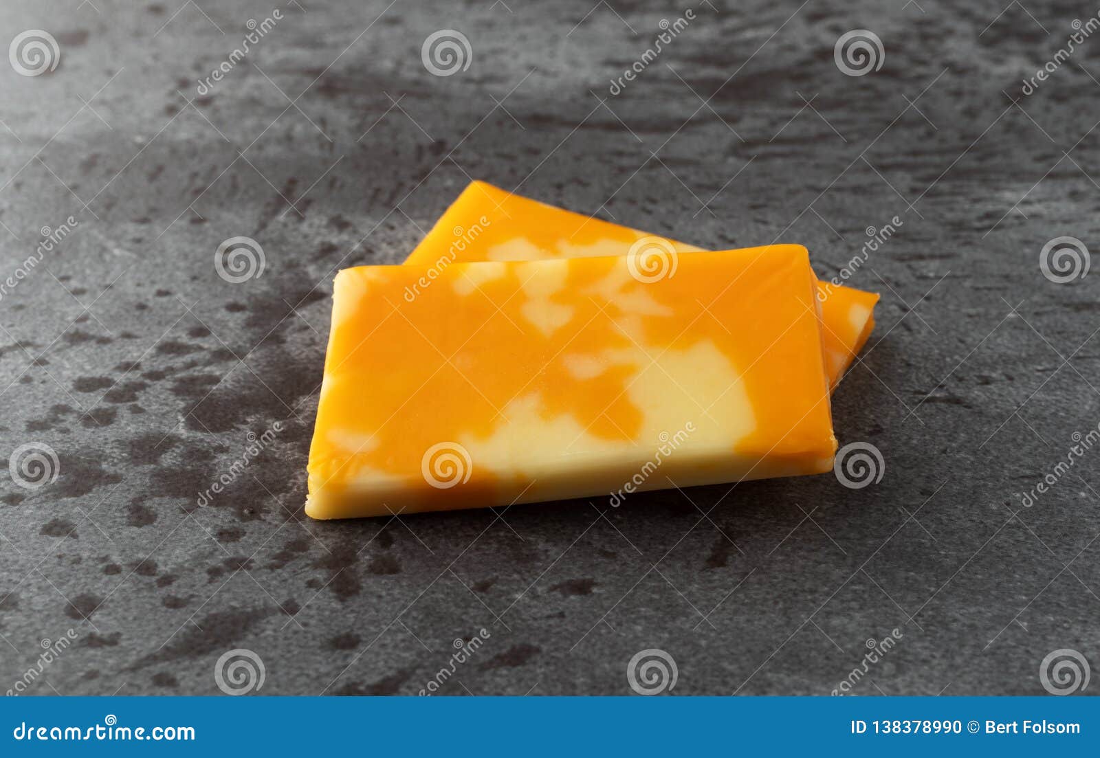 Two Colby Jack Cheese Bars on a Gray Background Side View Stock Photo