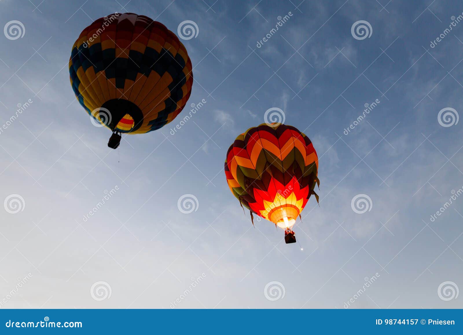 Two Colorful Hot Air Balloons Float Away into the Blue Sky Stock Image