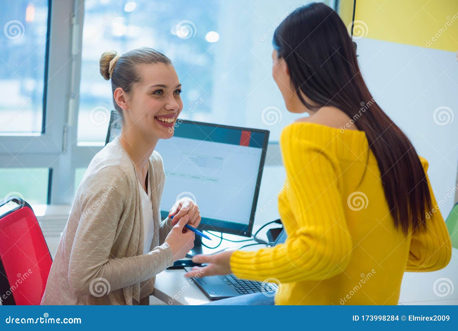 two creative femele office workers collaborate together to discuss main ideas for creating businness investment plan, analyze