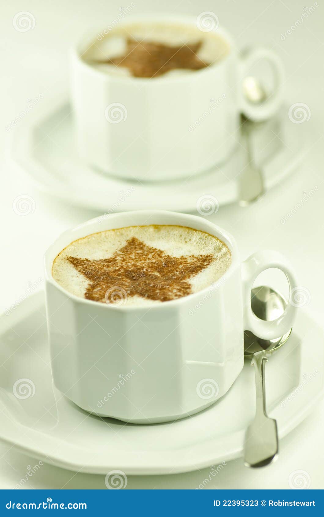 two cups of capuccino on white background