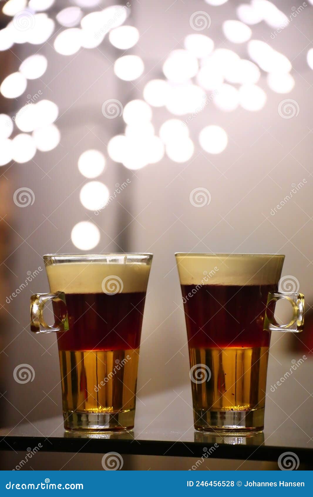 two cups of the layered cocktail blabarsputte, consisting of licor 43, blueberry soup, and cream