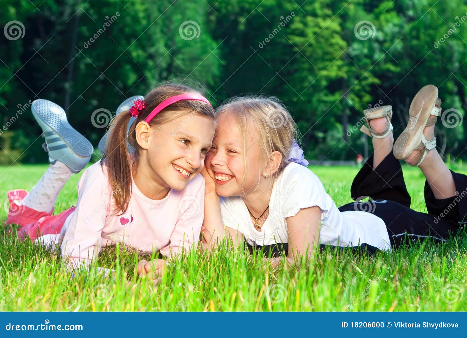 Two Cute Girls Laughing on the Grass Stock Photo - Image of little ...