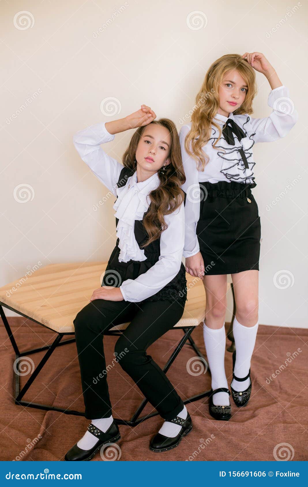 Two Cute Girls Schoolgirls with Long Curly Hair in Fashionable School ...