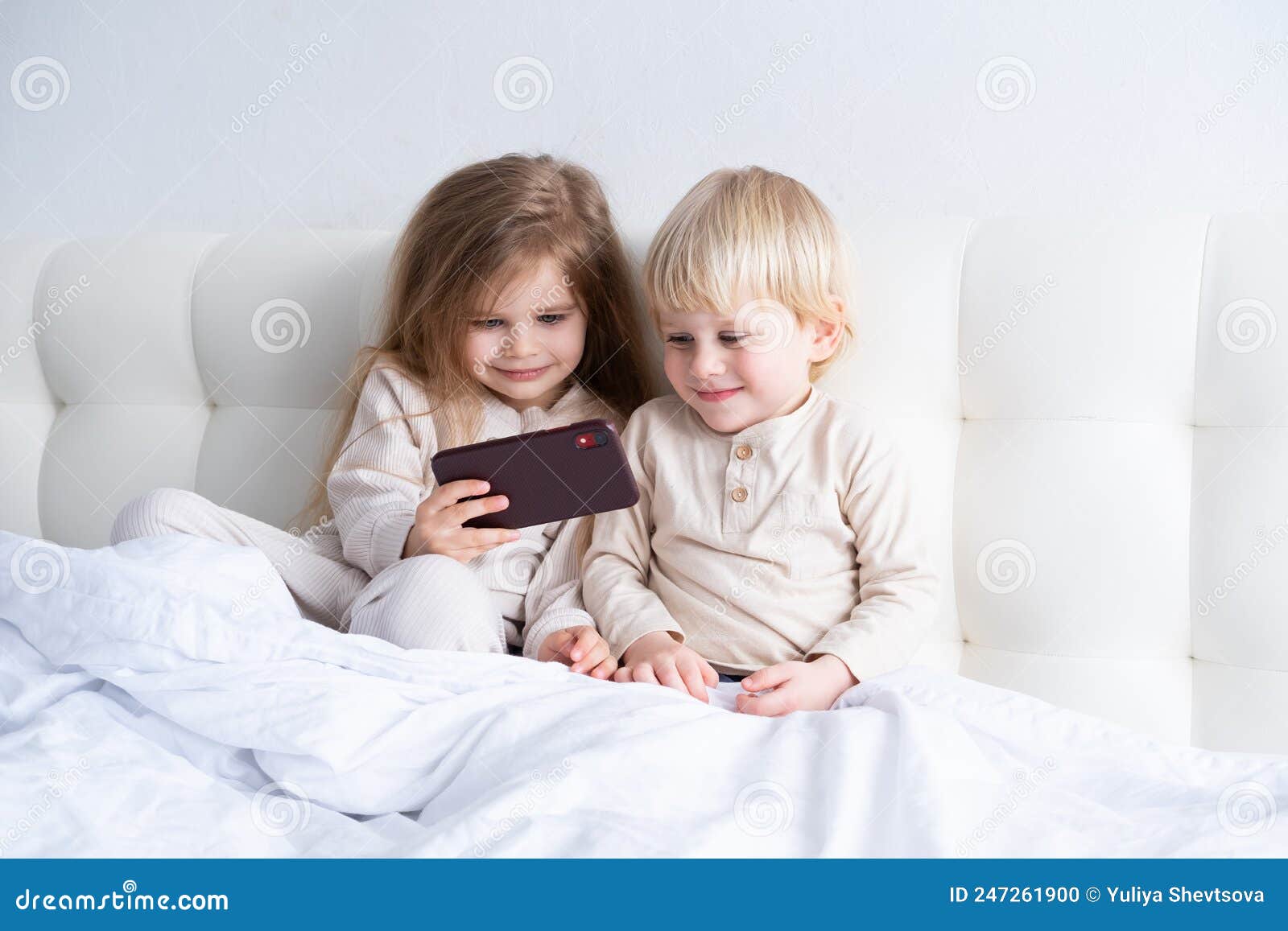 Two Cute Kids Girl and Boy Brother and Sister Using Phone Sitting on ...