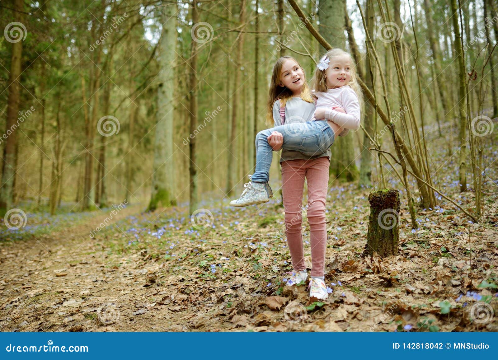 Two Cute Young Sisters Having Fun During Forest Hike On Beautiful Early Spring Day Active 