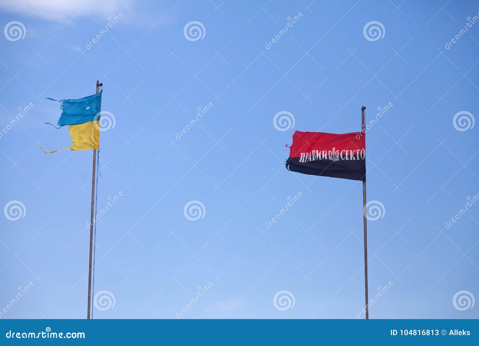 two damaged flags by ukraine and by arms of ukrainian nationali