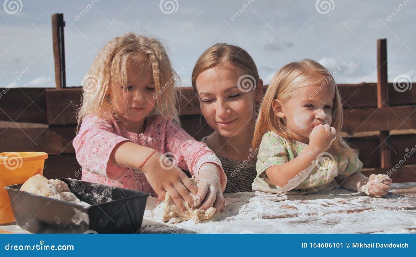 Two Daughters Knead The Dough With Their Hands Next To Their Mother Homemade Bread Baking