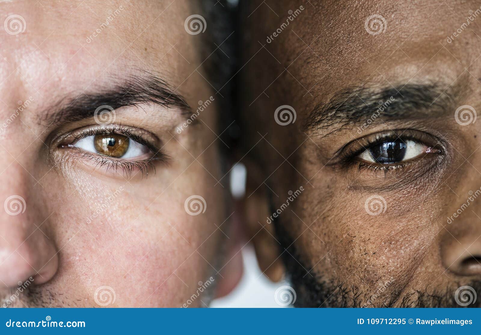 two different ethnic men`s eyes closeup