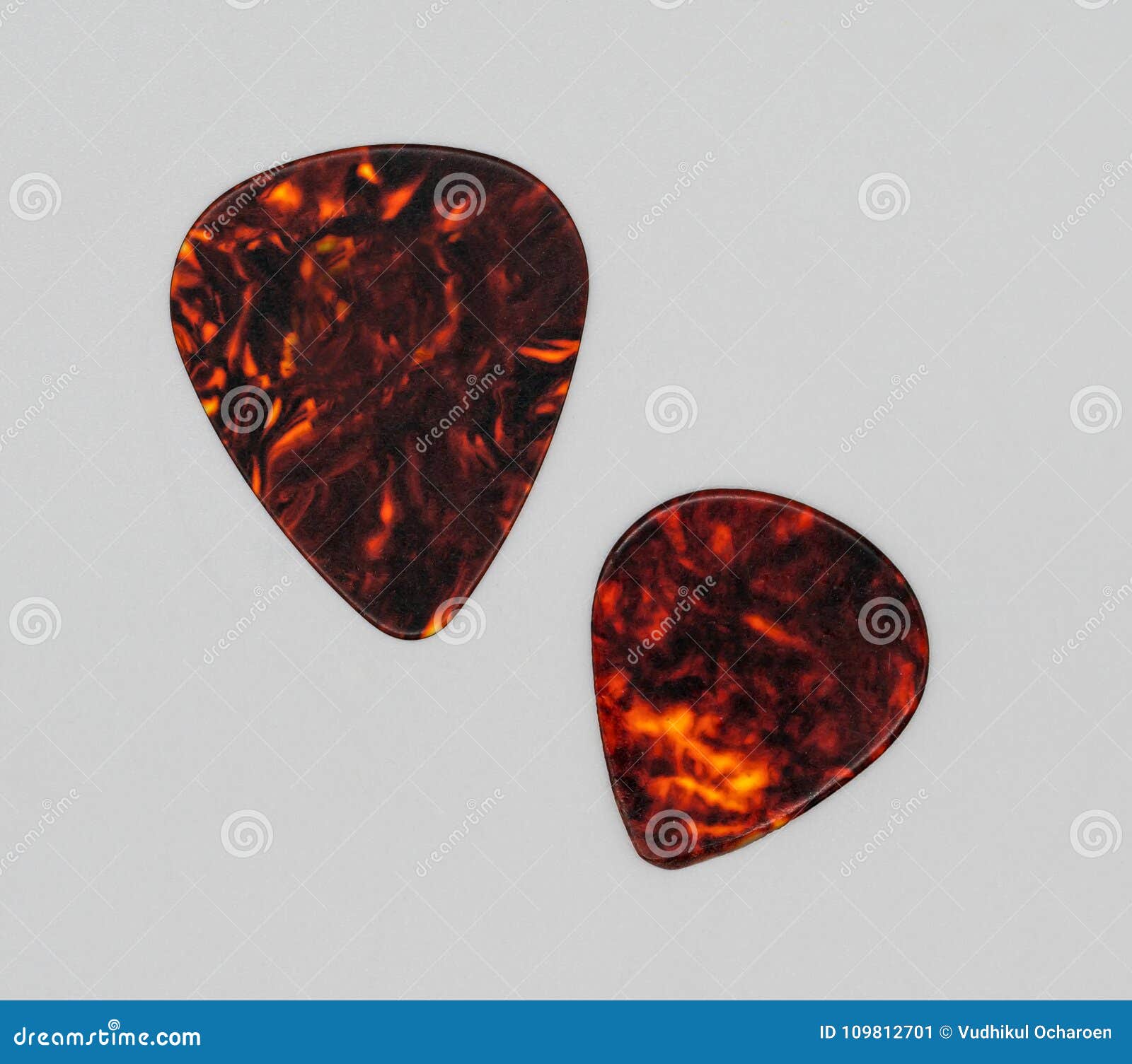 Two Different Sizes of Brown Plastic Guitar Plectrum Isolated on Stock