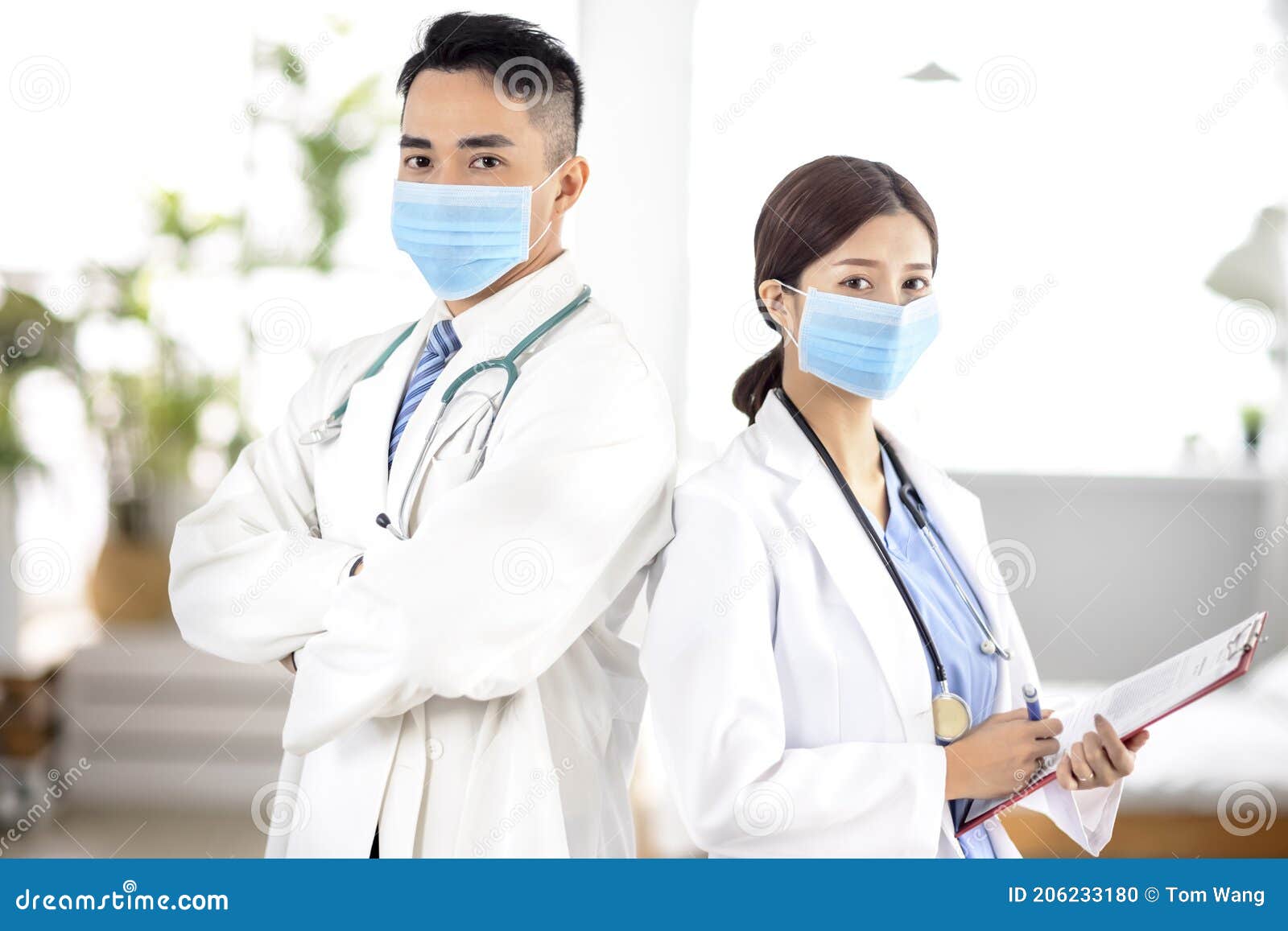 Two Doctors Faces Wearing Protective Mask in Hospital Stock Photo