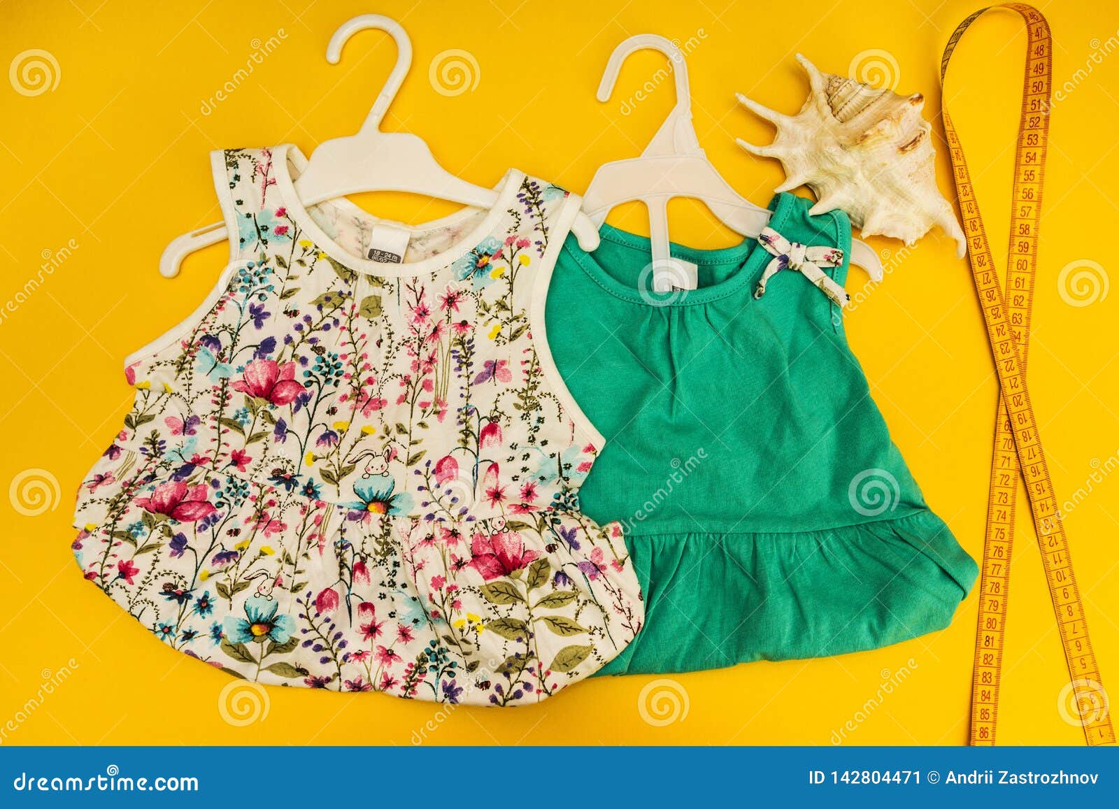 The Two Dresses for the Little Girl on a Yellow Background Stock Image ...