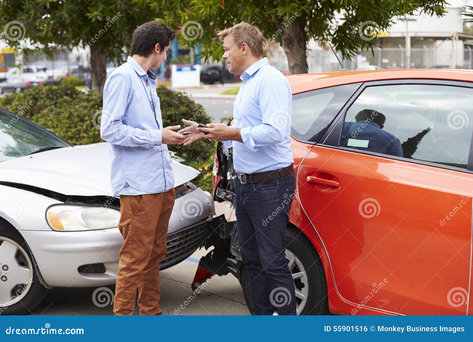 Two Drivers Exchange Insurance Details after Accident Stock Photo