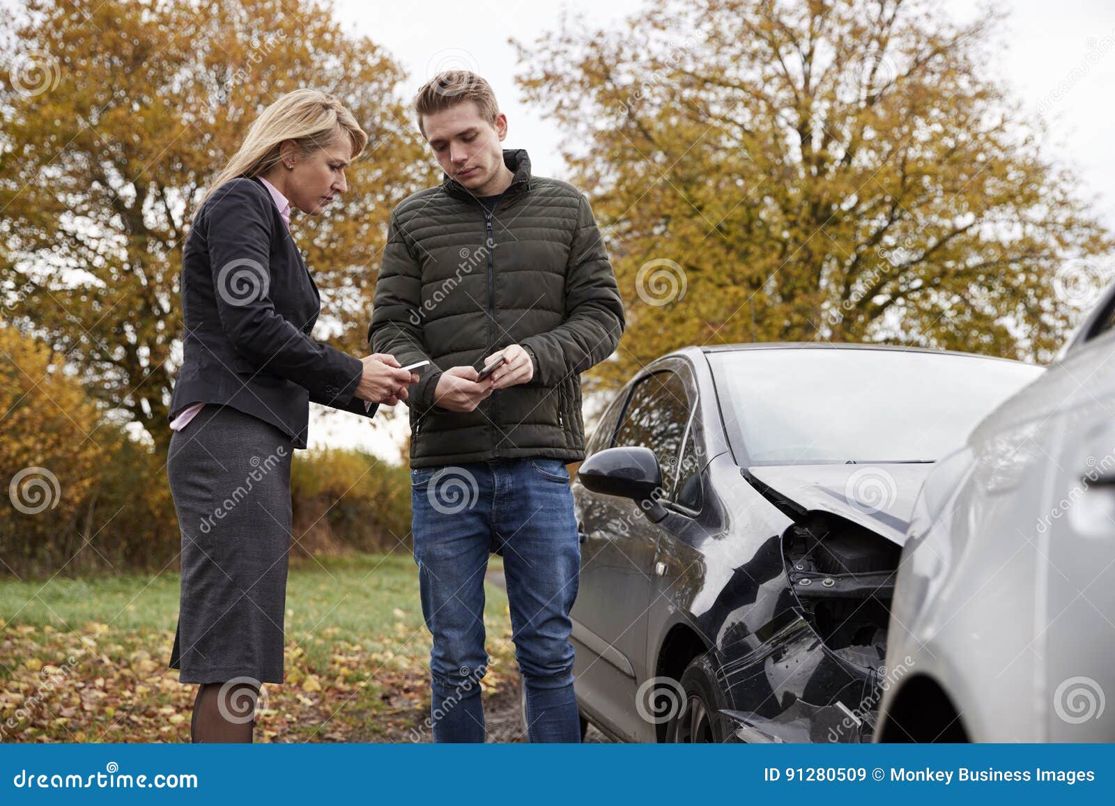 Two Drivers Exchanging Insurance Details After Car