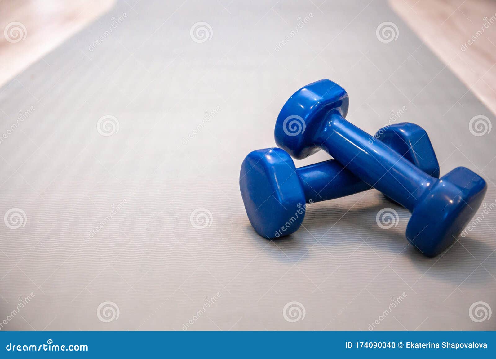 Two Dumbbells Close-up on a Gray Training Mat Stock Photo - Image of ...